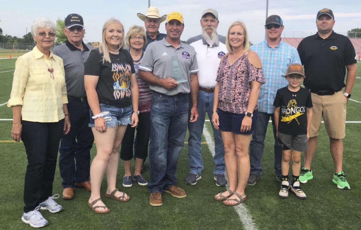 Wade Edis surrounded by family last Saturday after he was inducted into the Eight-Man Football Hall of Fame. Pictured l-r: Pat and Bob Edis, Jaci Edis, Peggy and Bob Marsh, Wade Edis, Coach Mike Brown, Jeri Edis, Lane Edis, Kyler and Wade Marsh. Barb McIntosh