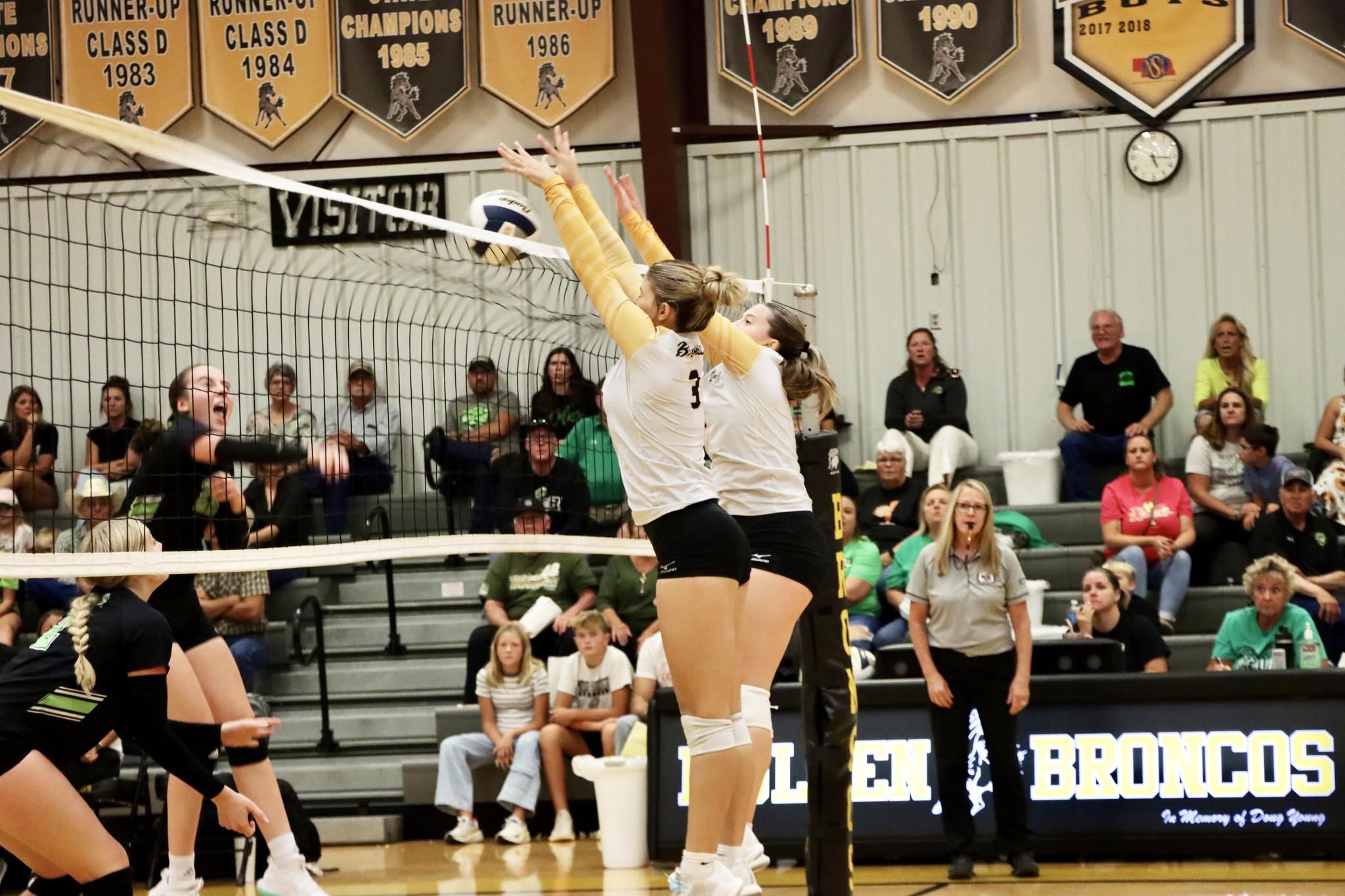 Seniors Medora DeNaeyer and Izzy Hoyt go up with the double block last week against Maywood-Hayes Center.