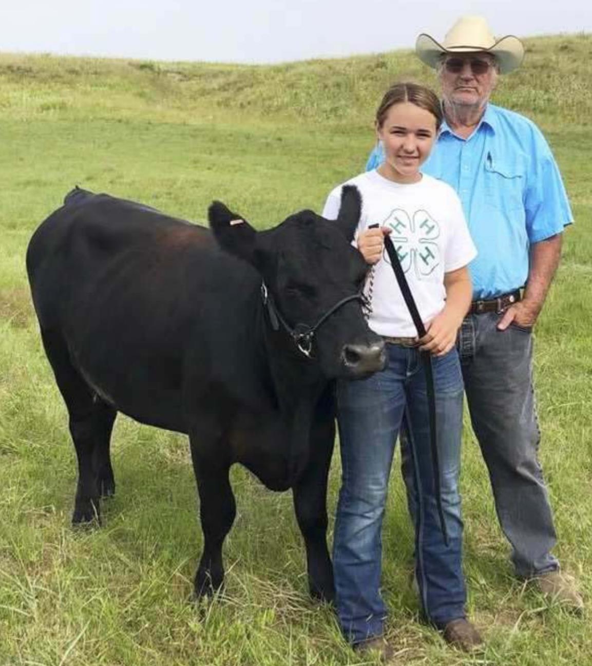 Izabella Brown with her grandpa Mike Connell at the 4-H Livestock Show. courtesy photo