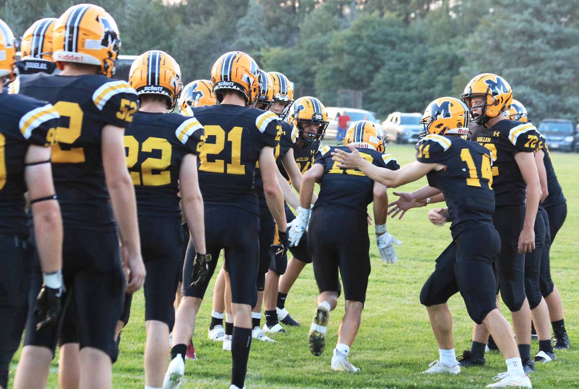 The Broncos cheer on each other as the starters run through a tunnel of their teammates as they are announced last Friday night. Carolee Brown Photography