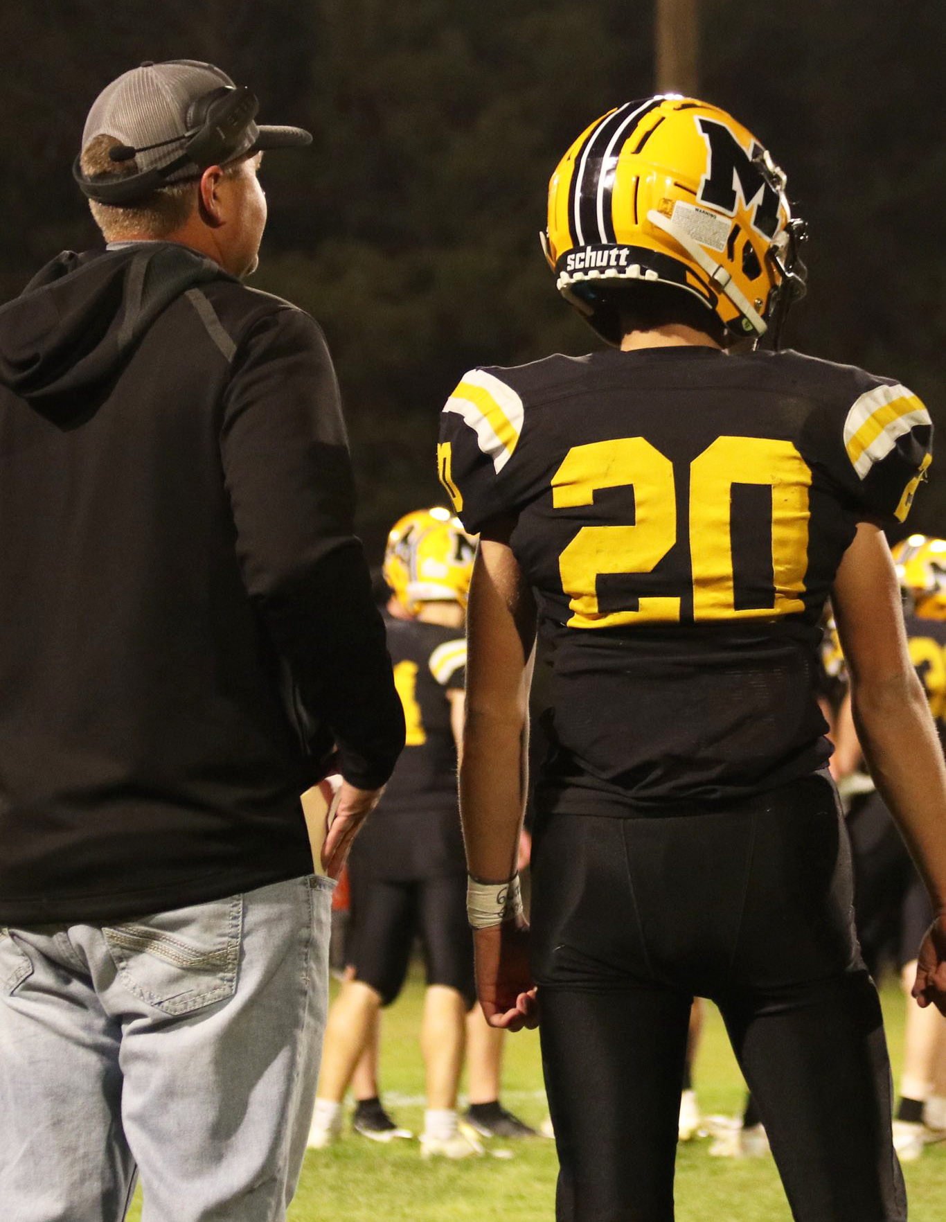 Quarterback Bo Pettit, Jr., waits for the play call from Head Coach Wade Marsh last Thursday night. Carolee Brown Photography