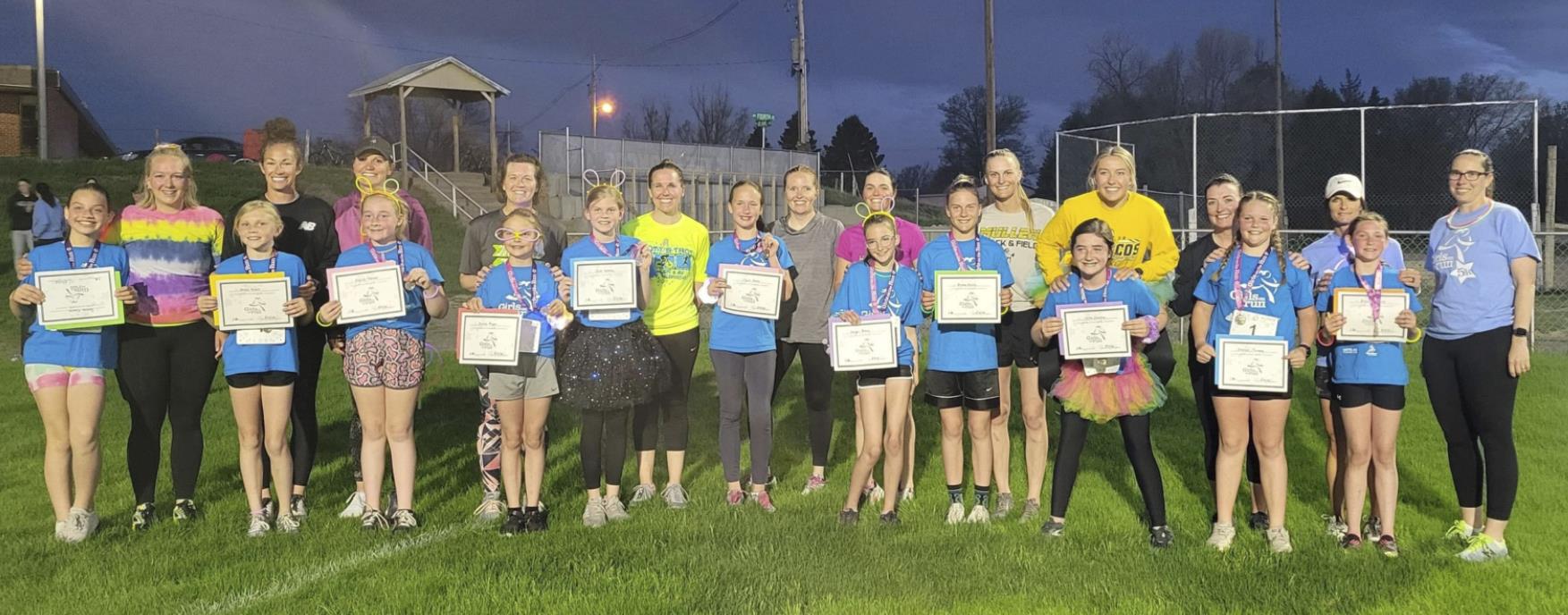 Girls on the Run participants and Buddy Runners after their 5K Glow Run last Friday night. The girls were coached by Bri Moore and Brynn Burney. courtesy photo