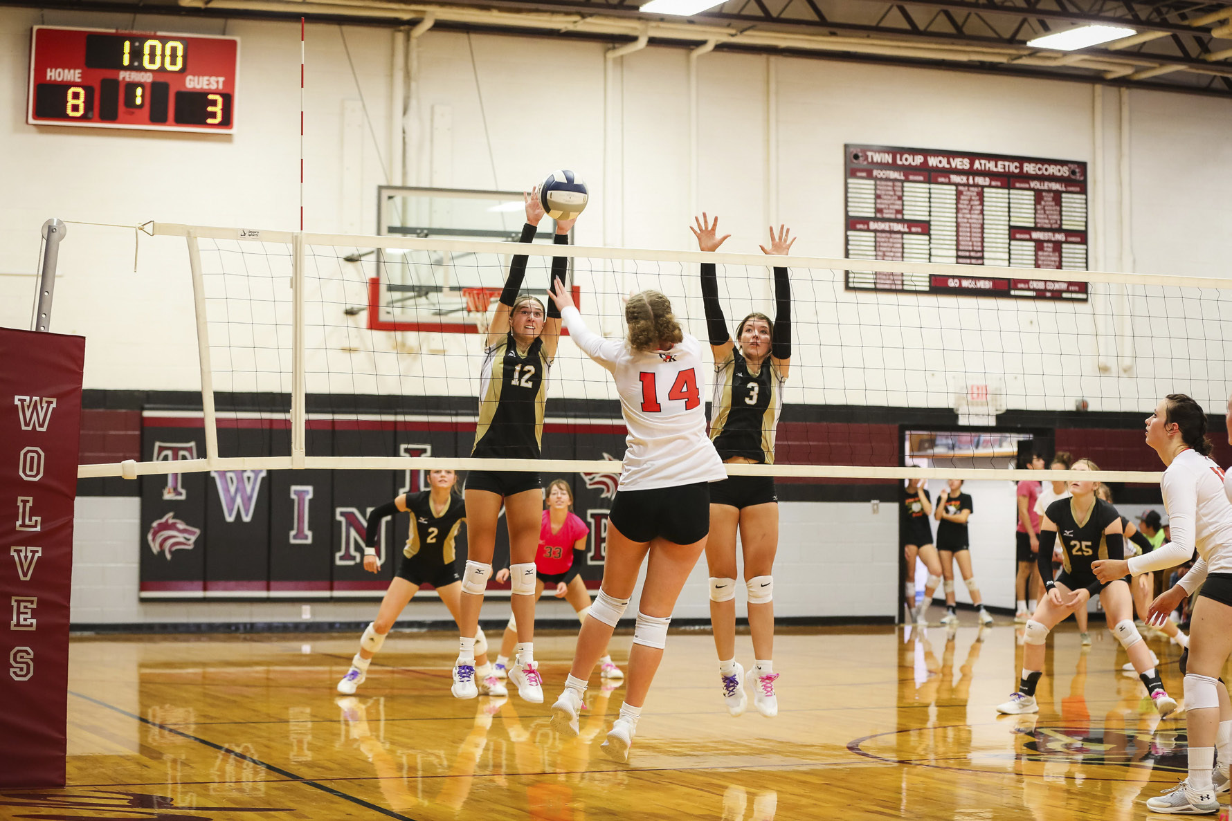 Allie Boyer with a block at the triangular in Taylor. Megan Andersen