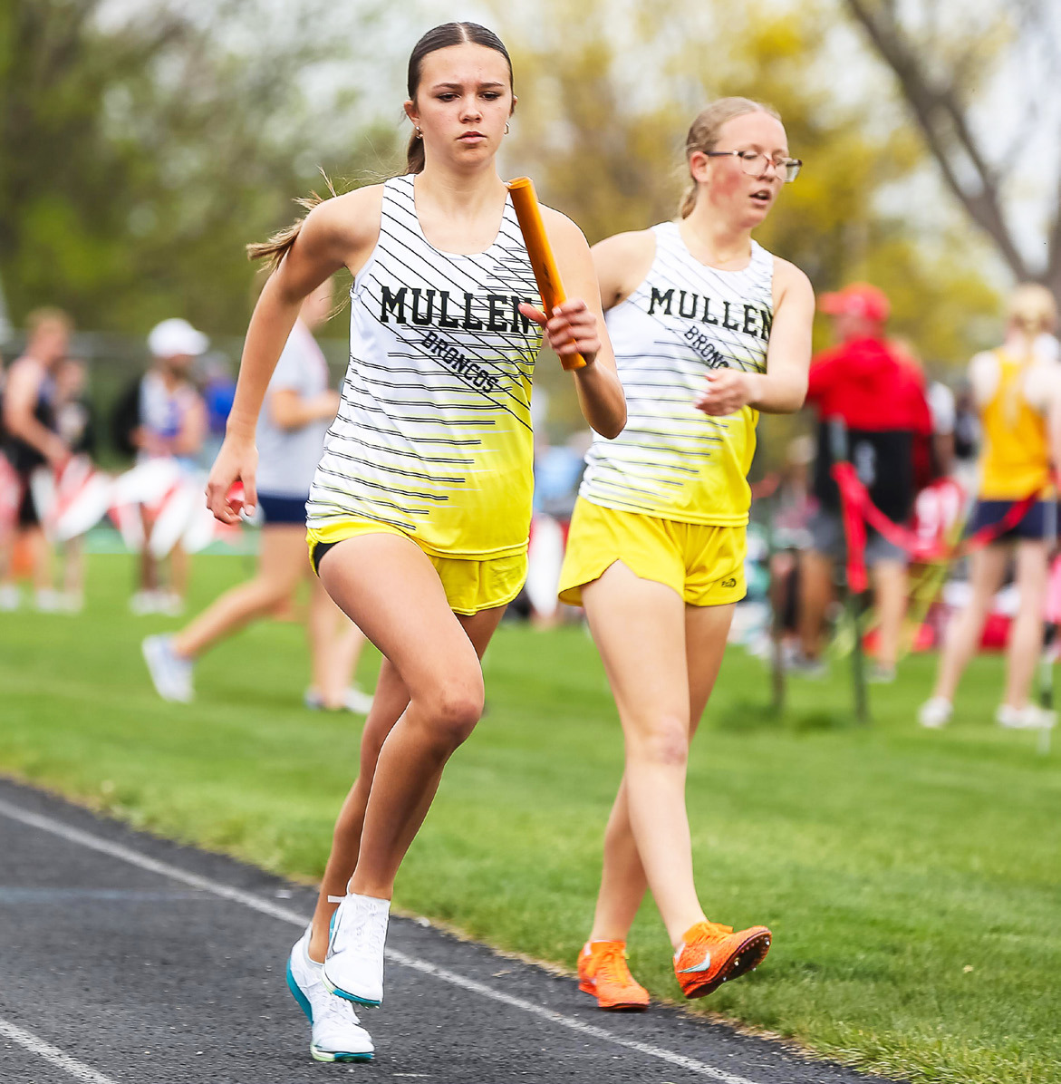 Ady Hampton starts her leg of the 4x8 relay at Sutherland after getting the baton from Riley Hegland. Megan Andersen