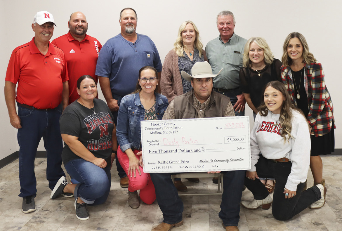 Dusty Paxton and his big check with Hooker County Community Foundation board members, back-r: Ron Boyer, Casey Phillips, Larry Ridenour, Yvonne Andrews, Kirk Jacobs, Barb Svoboda, Kara Connealy. Front: Stacy Kraye, Gerri Peterson, Dusty, Addie Lovitt. Not pictured: Mary Lou Harding, Scott Jones, George Vinton. Paxton donated his winnings to Hooker County Transit. Shirley Osborn