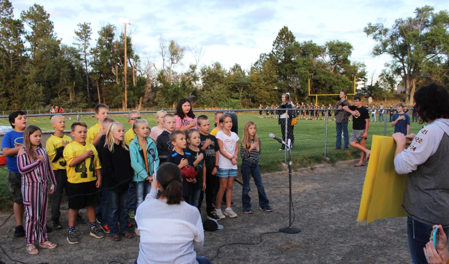 2nd-3rd grades sing national anthem at football game