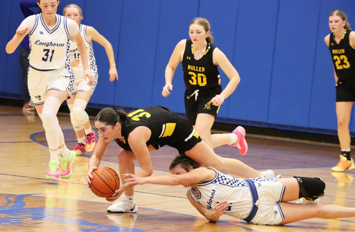 Jenna Donohoe holds onto the ball as she trips over a Hyannis defender last Thursday. Sue Licking