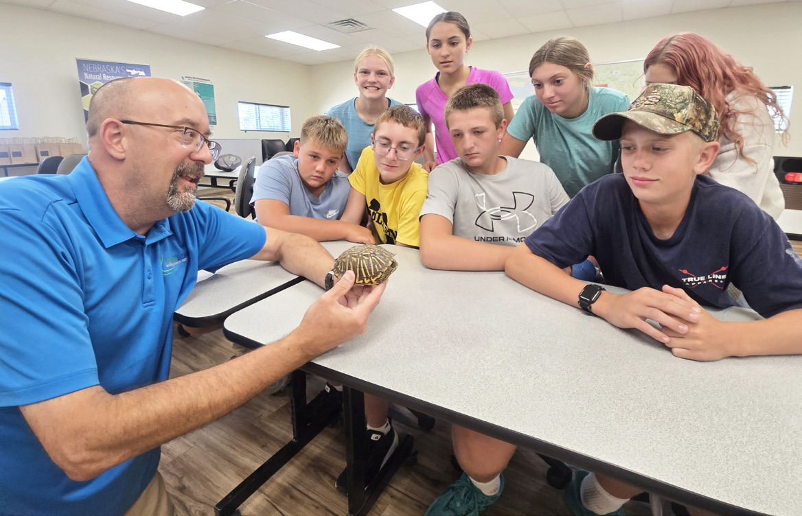 Last Wednesday, Aug. 26, the Mullen 8th graders attended the Upper Loup NRD field day in Thedford. They attended seven sessions that included forestry, wildlife, water, soils, range, NRD and biodiversity. It was an educational and fun day. Pictured at the session with Alan Bartels are Carson Hegland, Ava Walz, Cooper Cash, Luciana Gonzalez, Hayden Deibler, Olivia Cox, Bella Coetzee and Weston Ourada. Tawn Jewell
