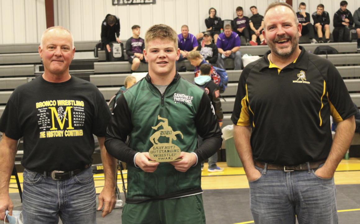Sandhills/Thedford’s Reece Zutavern was awarded the Gary Hoyt Outstanding Wrestler Award at the Bronco Invite by Gary’s sons Phil Hoyt (left) and Kyle Hoyt. The coaches voted for the award at the end of the tournament to determine the recipient. Kris Forsen