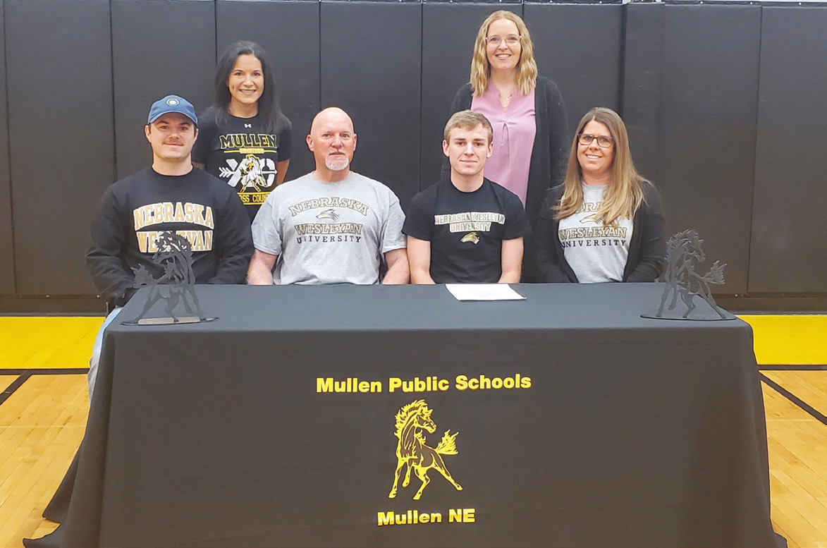 Mullen High School senior Kyle Finney signed his letter of intent to run cross country and track at Wesleyan University last Wednesday, March 6. Kyle is pictured with his parents, Scott Finney and Lori Finney, and brother Jared. Also pictured are MHS cross country coach Janie Kuncl (back left) and one of the MHS track coaches, Sarah Hardin. Mike Kvanvig