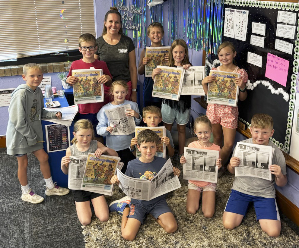 The Mullen third grade class is pictured with their copies of the Tribune and Kid Scoop News, standing, l-r: Jaxson Barnes, Cooper Ourada, Gerri Peterson of the Tribune, Kayden Evans, Kinley Crisp, Brogan Jewell. Kneeling: Meyer Vinton, Anna Ridenour, Tate Phillips, Merick Lattin, Aurora Polt, Harrison Vinton. Mollie Finney