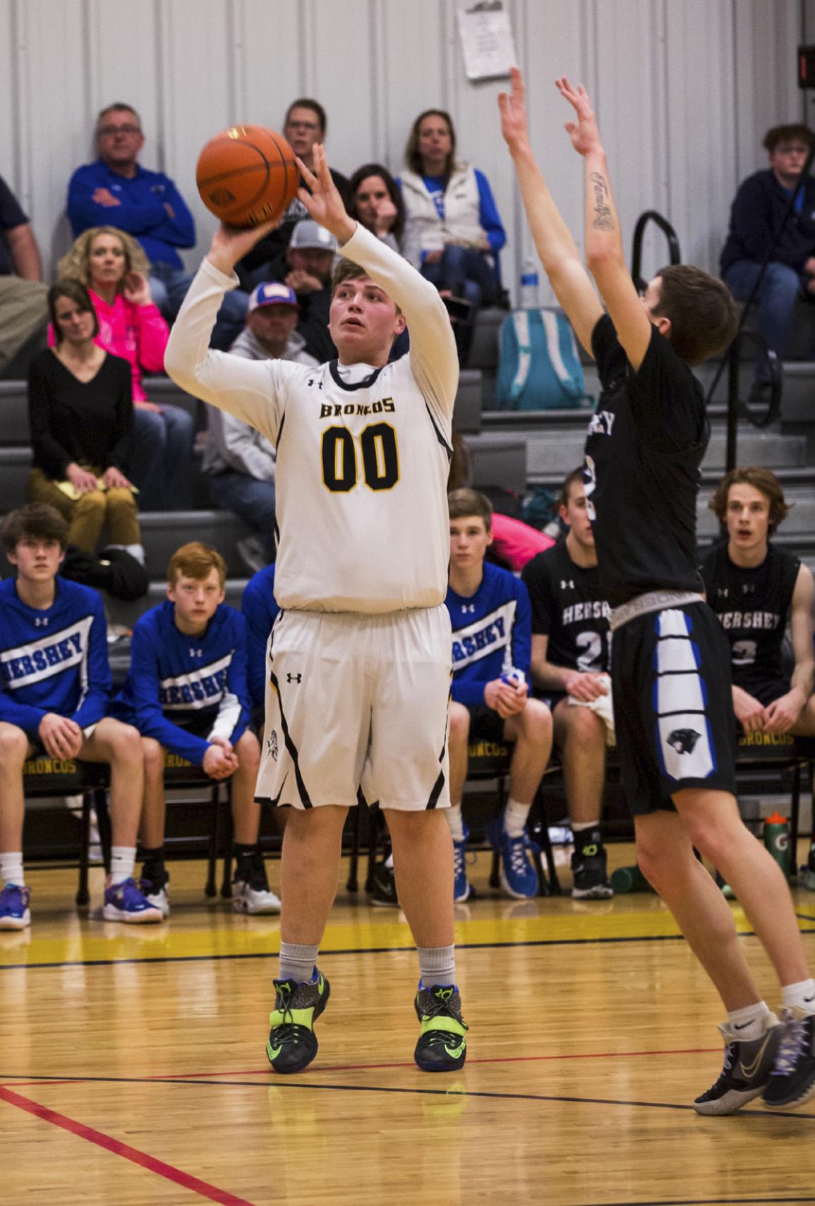 Senior Cade Groseth puts up a three pointer last Tuesday against Hershey. Megan Andersen