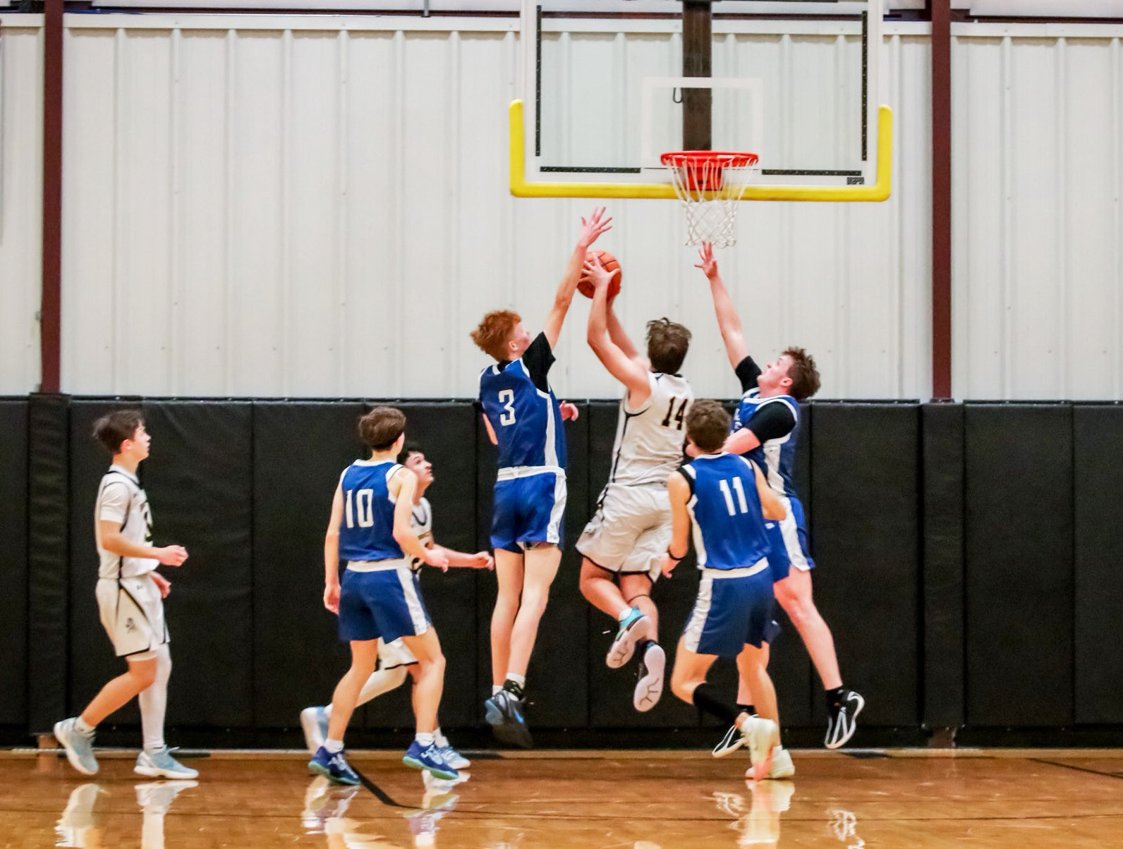 Jacob Walker makes a move to the basket between Hershey defenders last Friday night. Carolee Brown Photography
