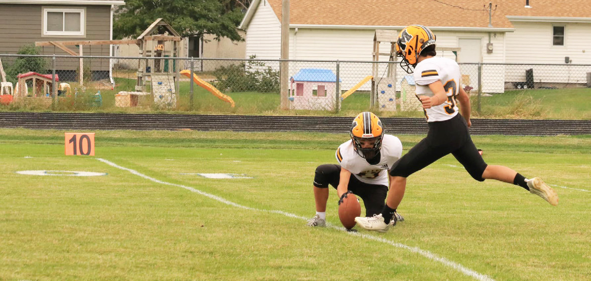 Ben Werner holds the ball for a Nicholas Gonzalez PAT kick. Carolee Brown