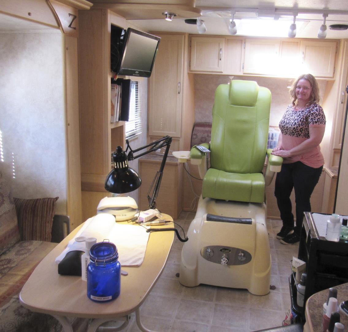 Barbie Neal stands in her mobile unit for Tips &amp; Toes. Marcia Hora