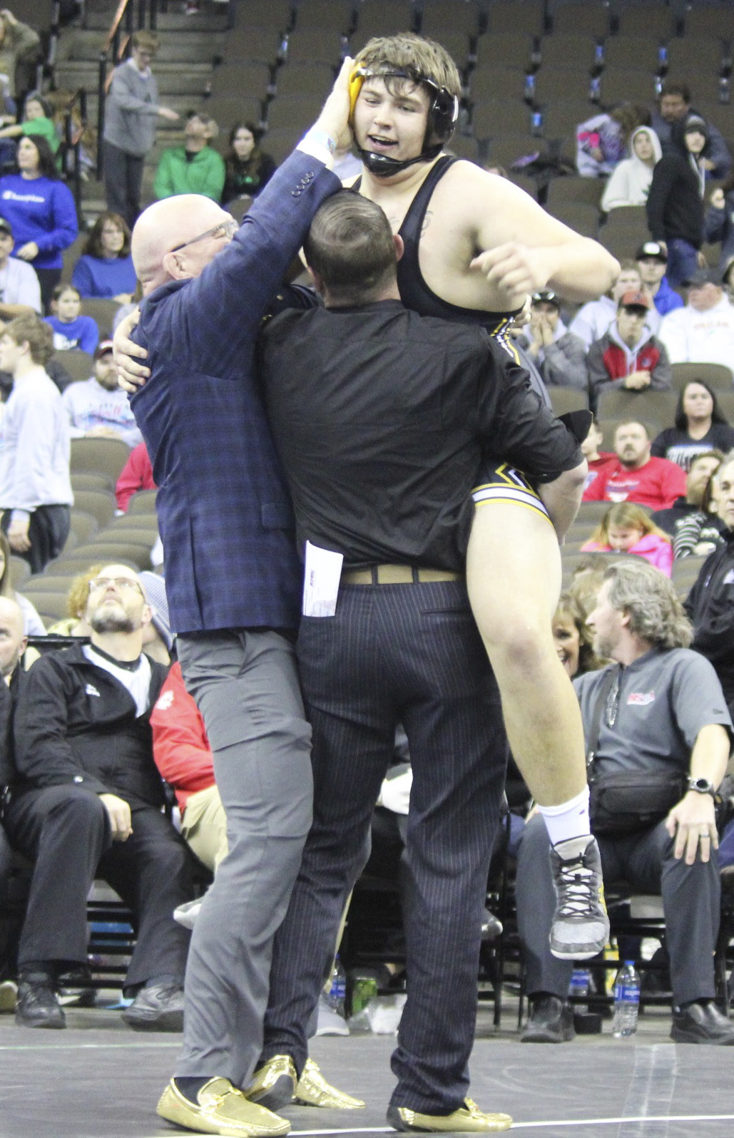 MHS senior Isaac Welch celebrates his gold medal win with Head Coach Russ Monette (left) and Assistant Coach Bo Pettit.