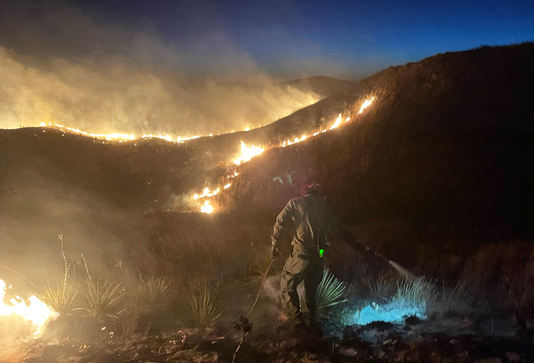 U.S. Forest Service firefighter Ben Pickering battles the fire at peck hill south of Mullen last Tuesday evening. Dane Peterson