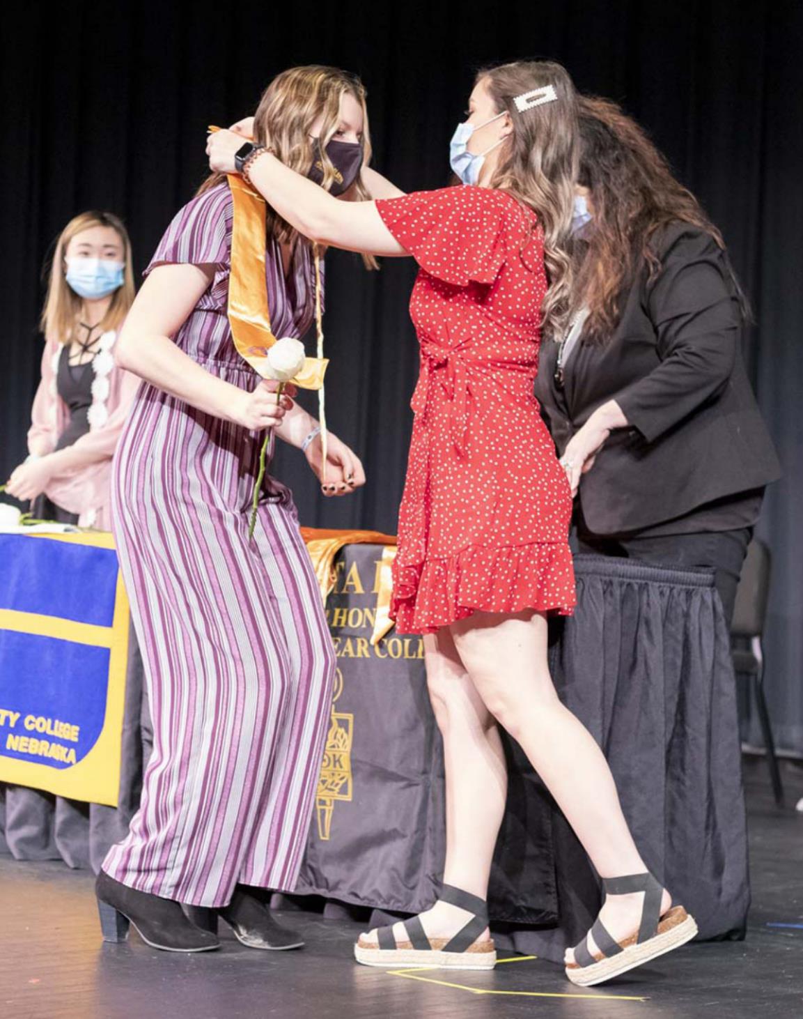 Alysen Daniels receives a gold stole during the PTK induction ceremony Sunday at North Platte Community College. Heather Johnson