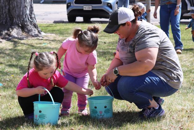 Libby and Ruby Kraye check out their baskets with their mom, Stacy Kraye.