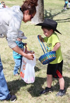 Brek Dent unloads his basket to mom Kay Dent before running off for more.