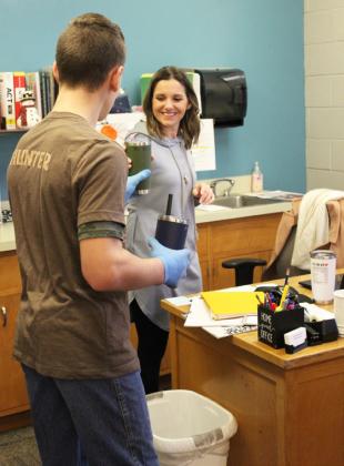 Hunter Brown delivering Ms. Kara’s drink to her office.