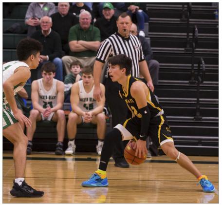 Trevor Kuncl dribbles between his legs last Tuesday in State Basketball action.