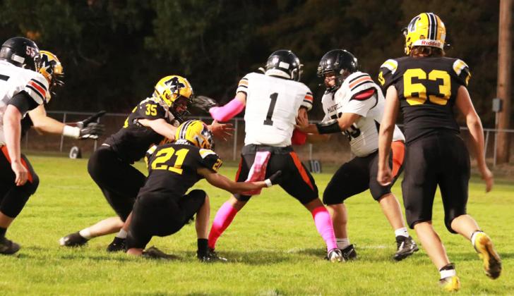 Cooper Walker and Cayden Hampton with the tackle, while Jarren Forsen looks on.