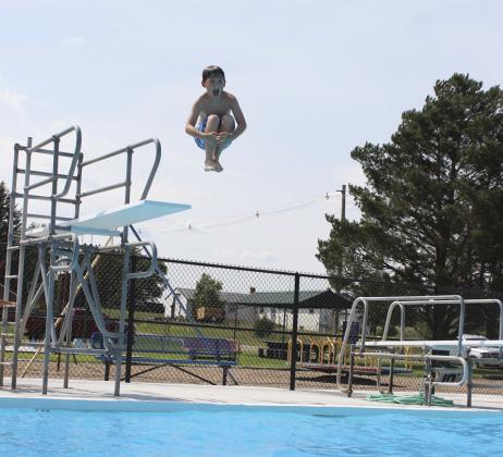 Zach Hicks lets out a shout as he jumps into the water during the biggest splash off of the high board at the Water Carnival. Gerri Peterson