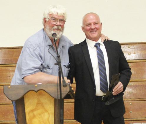 After John Kraye (left) was named the MHS Fan of the Year, he told MHS Athletic Director Phil Hoyt and the audience, “You’re really scraping the bottom of the barrel.”