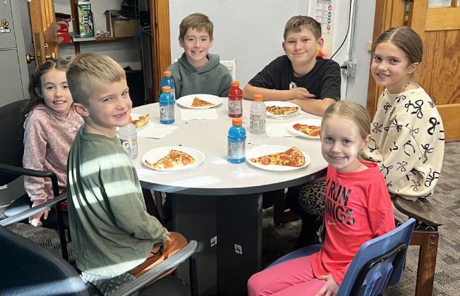 Pictured around the table, clockwise from bottom left: Tate Seeley, Addi Mundorf, Eli Garza, Cooper Phillips, Madelyn Seeley, Aurora Polt. Brett Mauler