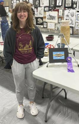 Malia Oltmer with her beaded landscape mixed media piece that won Best of Show.