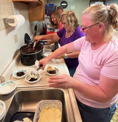 The Assembly of God Church ladies were dishing up brownies and scooping ice cream and toppings like hot fudge as fast as they could Saturday afternoon, Aug. 1, during their ice cream social! Pictured l-r: Linda Boyer, Teresa Hampton, Jamie Hart. Gerri Peterson