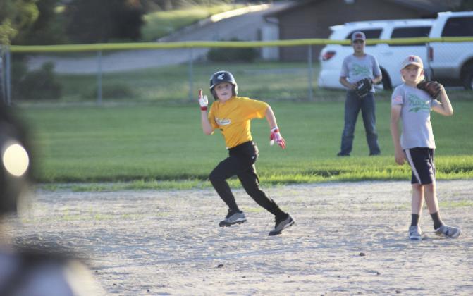 Zach Hicks keeps his eye on the catcher as he heads to steal third base during the baseball game Monday night against Thedford. Gerri Peterson