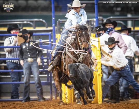 Kirby Eppert in action last week with Katie Mundorf standing in the box behind her. ProRodeo Photos by Joe Duty