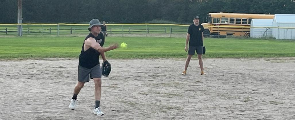 Despite the temperature earlier in the day climbing over 100, there were 22 participants in the Hooker County Fair slow pitch softball game Sunday evening, July 26. Pictured are Brandon Cooley and Jaden Emerson. Barb McIntosh