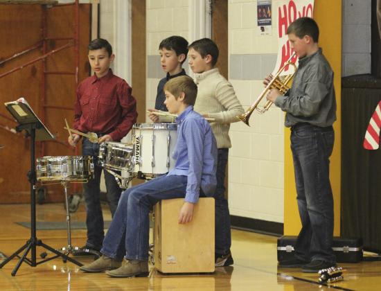Part of the 5th grade band members, standing l-r: Gunner Brown, Brandt Mundorf, Colin Connealy, Cort Cox. Justin Kraus on the slap box.