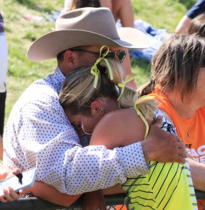 Peyton Paxton collapses into the arms of her dad, Dusty Paxton, following her 5th place finish in the 1600.