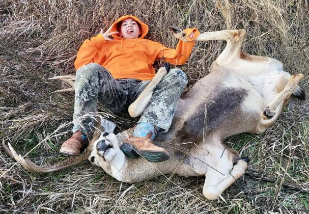 Mary Lou Harding submitted this photo with the following description: “Our precocious granddaughter holding the leg of the buck her sister shot. Because that’s usually her job, hold the leg so the gutting process can proceed.”