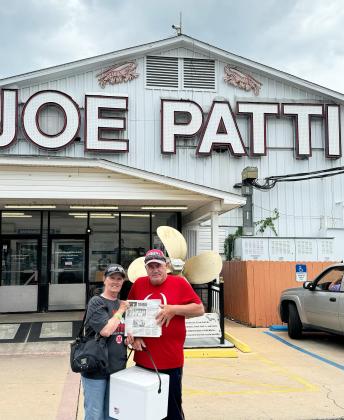 Dick and Tammy Simonson took the Tribune with them on a trip south in May. They are pictured in Pensacola, Florida, at Joe Patti’s Seafood.