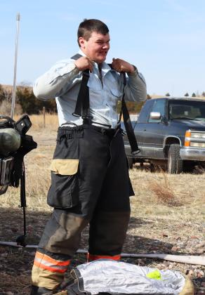Owen Thorberg of Mullen gets his gear on before equipment checks.