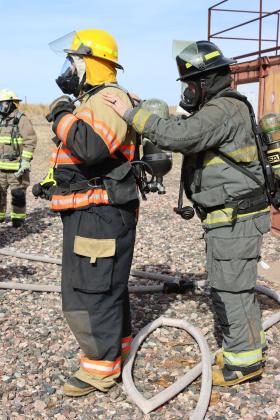 Instructor Tyrell Wilson does equipment checks before allowing the firefighters to enter the training center before the live fire.