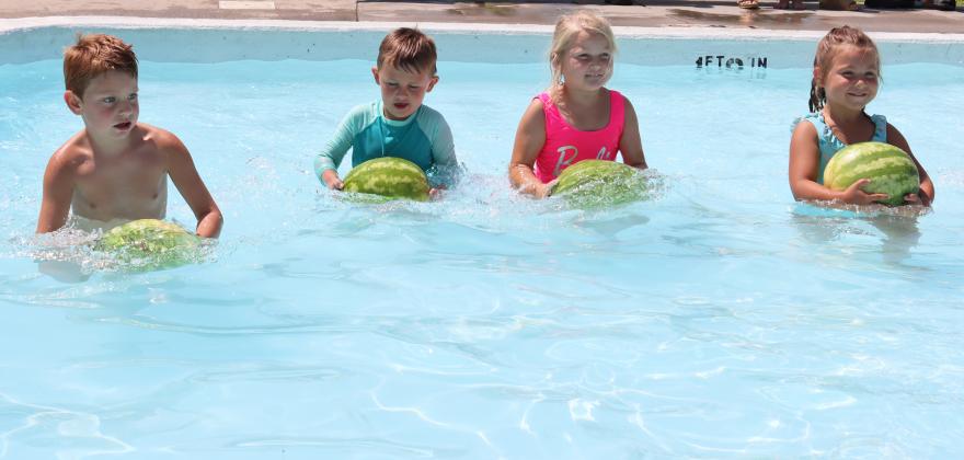 L-r: Clay Cribelli, Chasin McIntosh, Violet Stichka and Quinley Schmid compete in a heat of the baby pool watermelon race.