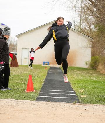 Ella Rice competing in the long jump at Burwell.