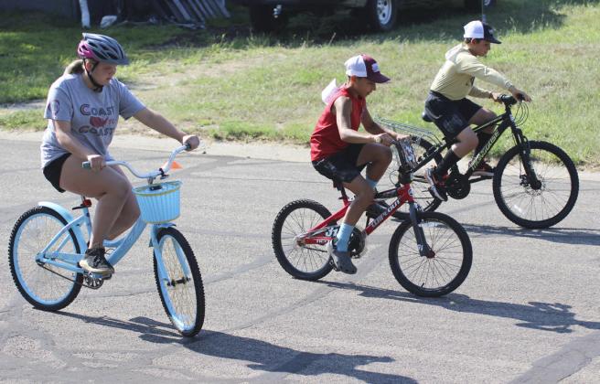 L-r: Maci Walz, Gunner Brown and Colin Connealy compete in the 4th-6th grade slowest race at the Bicycle Rodeo last Wednesday. Gerri Peterson
