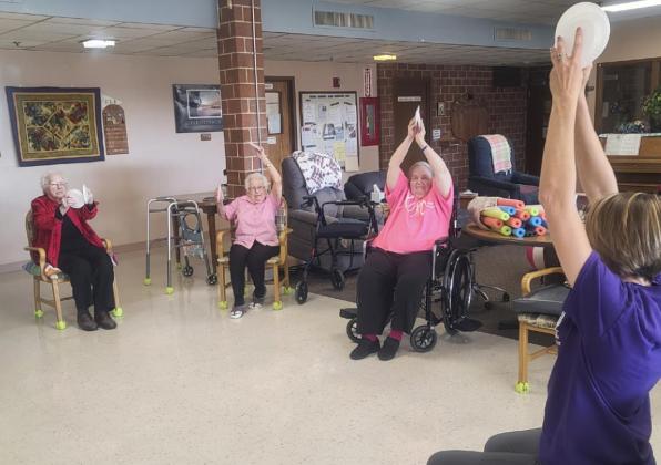 Rebecca Welsh doing restorative upper body exercises with the residents, l-r: Minnie Mary Hamilton, Nadene Andersen and Ann Connell.