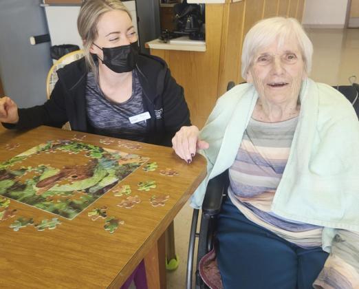 Marlene Dykes and Becca Connealy working on a puzzle