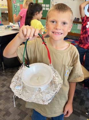 The 2nd grade students recently investigated which kinds of birds are likely to visit a bird feeder based on what they eat. They learned about what attracts specific birds to different feeders. Students then drew a picture of the bird feeder they wanted to create to attract a particular bird and built that bird feeder using available materials. Each student took their bird feeder and birdseed home to see if it worked! Pictured are Abigail Gonzalez and Trent Cox with their bird feeders. Emily Brown