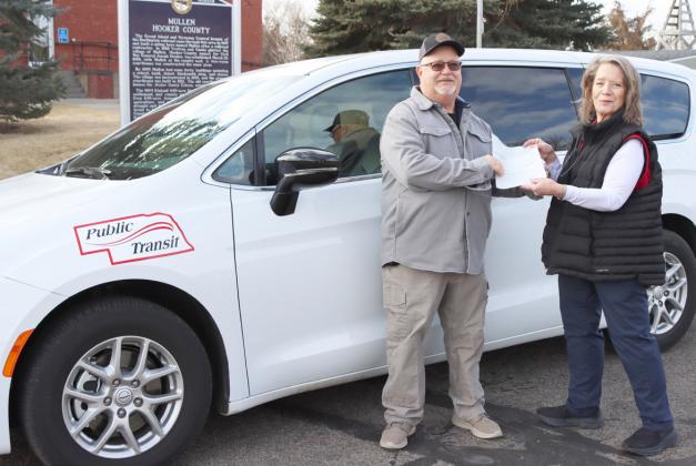 Doug Boyer is pictured accepting checks from Jonnie Kusek, Nebraska’s Open Plains Transit Coordinator. Gerri Peterson