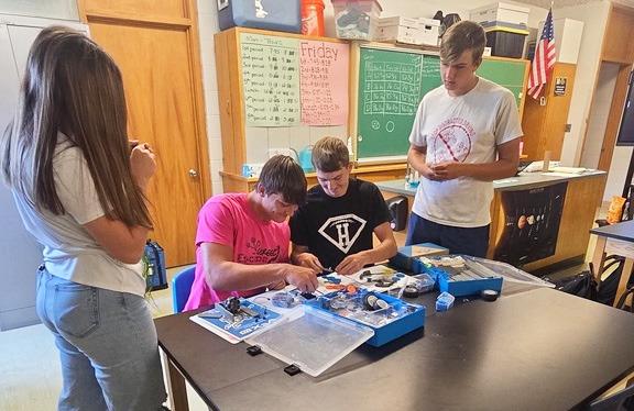 L-r: MHS juniors Toni Massey, Tate Kvanvig, Cayden Hampton and Jacob Walker at the VEX robotics STEM station. The STEM trailer was developed by Custer Public Power District and BD Medical to bring hands-on STEM stations to the rural schools that CPPD supplies power to. MHS gets four stations for 12 weeks at a time, every other year. Tawn Jewell