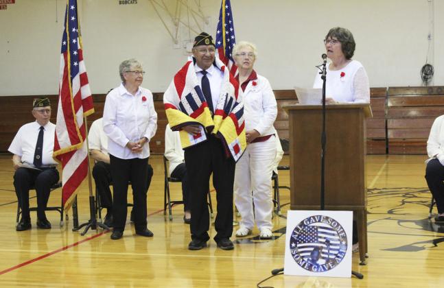 Don Younkin with his Quilt of Valor as Eva Crawford reads about his military experience. Also pictured standing are Sherron Sullivan (left) and Doris Starr who helped with the presentation.